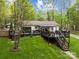 Spacious back deck with black railings and stairs, overlooking a large, well-maintained yard at 214 Creek View Rd, Mooresville, NC 28117