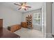 Bright bedroom with a wooden dresser, glass cabinet, and carpeted floor at 214 Creek View Rd, Mooresville, NC 28117
