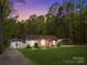 Charming home with a well-manicured lawn, complemented by a garage and carport in a serene setting at 214 Creek View Rd, Mooresville, NC 28117