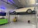 Spacious garage with car lift and a classic white vehicle, perfect for car enthusiasts at 214 Creek View Rd, Mooresville, NC 28117