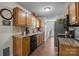 Well-lit kitchen featuring wood cabinets, granite countertops, stainless steel appliances, and tile flooring at 214 Creek View Rd, Mooresville, NC 28117