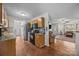 Open-concept kitchen with stainless steel appliances, wooden cabinets, and tile floor, leading to the living room at 214 Creek View Rd, Mooresville, NC 28117