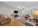 Cozy living room featuring hardwood floors, comfortable seating, and a large window overlooking the yard at 214 Creek View Rd, Mooresville, NC 28117