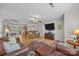 Cozy living room features a large leather sofa, modern television, decorative rug, and open access to the kitchen at 214 Creek View Rd, Mooresville, NC 28117