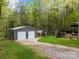 View of a large garage building and a covered outdoor space in the backyard at 214 Creek View Rd, Mooresville, NC 28117