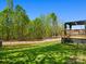Beautiful backyard with lush greenery, mature trees, a deck, and a fenced perimeter at 2234 Emerald Mine Rd, Shelby, NC 28152
