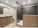 Modern bathroom featuring dual sinks, a toilet, and a large tiled shower with glass at 2234 Emerald Mine Rd, Shelby, NC 28152