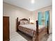 This bedroom features a wooden four-post bed and window with natural light at 2234 Emerald Mine Rd, Shelby, NC 28152
