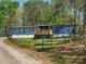 Home featuring a blue exterior with a wooden deck and a fenced yard with wooded surrounding at 2234 Emerald Mine Rd, Shelby, NC 28152