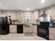 Bright kitchen featuring light wood cabinets, black appliances, and stainless steel farmhouse sink at 2234 Emerald Mine Rd, Shelby, NC 28152