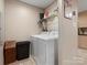 Functional laundry room with modern washer and dryer, shelving and storage at 2234 Emerald Mine Rd, Shelby, NC 28152