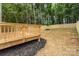 Backyard showcasing wooden deck, a newly installed wooden fence, and lawn at 2512 Remington St, Charlotte, NC 28216