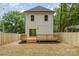 Backyard featuring wooden deck, sliding glass door, and a newly installed wooden fence at 2512 Remington St, Charlotte, NC 28216