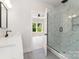 Bathroom featuring double vanities, glass shower, neutral tones, and natural light, creating a serene atmosphere at 2512 Remington St, Charlotte, NC 28216