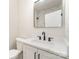 Modern bathroom featuring sleek vanity, marble counter, and a stylish black framed mirror at 2512 Remington St, Charlotte, NC 28216