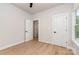 Neutral bedroom showcasing hardwood floors, white doors with black hardware and lots of natural light at 2512 Remington St, Charlotte, NC 28216
