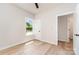 Well-lit bedroom featuring hardwood floors, closet, white trim, and a window offering views of the neighborhood at 2512 Remington St, Charlotte, NC 28216