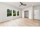 Bright bedroom featuring hardwood floors, white walls, large windows, and a closet space at 2512 Remington St, Charlotte, NC 28216