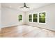 Bright bedroom featuring hardwood floors, white walls, recessed lighting and three windows at 2512 Remington St, Charlotte, NC 28216