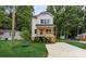 Charming new construction home with a covered front porch and lush green lawn at 2512 Remington St, Charlotte, NC 28216