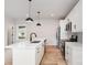 Modern kitchen features white cabinets, an island with a sink, and stainless steel appliances at 2512 Remington St, Charlotte, NC 28216