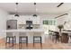 Modern kitchen with stainless steel appliances, a center island with seating, and an adjacent dining area at 2512 Remington St, Charlotte, NC 28216