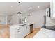 Modern kitchen featuring an island with a sink, stainless steel appliances, and views of the living area at 2512 Remington St, Charlotte, NC 28216