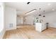 Open-concept living space featuring hardwood floors, modern lighting, and a seamless flow to the kitchen at 2512 Remington St, Charlotte, NC 28216
