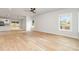 Sunlit living room featuring hardwood floors and large windows overlooking the backyard at 2512 Remington St, Charlotte, NC 28216