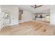 Bright open-plan living space featuring hardwood floors and a modern kitchen with stainless steel appliances at 2512 Remington St, Charlotte, NC 28216