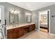 Bathroom with double sink vanity and a view into the main bedroom at 2532 Annecy Dr, Matthews, NC 28105