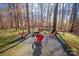 Backyard fire pit with seating, set in the trees, is ideal for outdoor gathering at 2532 Annecy Dr, Matthews, NC 28105