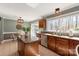 Well-lit kitchen featuring wood cabinets, a center island with a granite countertop, and stainless steel appliances at 2532 Annecy Dr, Matthews, NC 28105