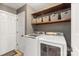 Laundry room featuring updated washer and dryer and storage shelves at 2532 Annecy Dr, Matthews, NC 28105