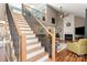 Inviting living room featuring vaulted ceilings, a fireplace, and an open staircase leading to a second floor loft at 2532 Annecy Dr, Matthews, NC 28105