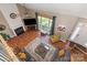 Open-concept living room featuring a fireplace, large window and hardwood floors at 2532 Annecy Dr, Matthews, NC 28105