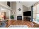 Comfortable living room showcasing a fireplace, a TV, and natural light flowing through a large window at 2532 Annecy Dr, Matthews, NC 28105