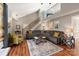 Bright and airy living room with modern decor, comfortable seating, and a staircase leading to the upper level at 2532 Annecy Dr, Matthews, NC 28105