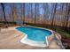 An in-ground pool is encased in concrete and is surrounded by trees and a fenced-in yard with a shed and lounge chairs at 2532 Annecy Dr, Matthews, NC 28105