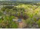 An aerial view reveals the home nestled amongst the trees with a long concrete driveway at 297 Barr Link Rd, Mount Pleasant, NC 28124