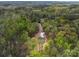 An aerial view shows the home tucked away in the woods, accessed by a long concrete driveway at 297 Barr Link Rd, Mount Pleasant, NC 28124