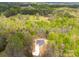 An aerial view shows the home nestled in a forest with a long driveway leading up to the house at 297 Barr Link Rd, Mount Pleasant, NC 28124