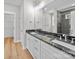 Bright bathroom with double sink vanity, black countertops, and large mirror at 297 Barr Link Rd, Mount Pleasant, NC 28124
