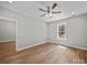 Bright bedroom with hardwood floors, ceiling fan and a window letting in natural light and view to the exterior at 297 Barr Link Rd, Mount Pleasant, NC 28124
