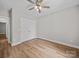 Bedroom featuring hardwood floors, closet, ceiling fan and a window letting in natural light and view to the exterior at 297 Barr Link Rd, Mount Pleasant, NC 28124