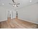 Spacious bedroom with wood-look flooring and two entry doors at 297 Barr Link Rd, Mount Pleasant, NC 28124