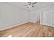 Neutral bedroom featuring wood-look flooring, fan, and ample natural light at 297 Barr Link Rd, Mount Pleasant, NC 28124