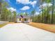 Charming single-story home featuring a light gray exterior, vibrant blue front door, and lovely landscaping at 297 Barr Link Rd, Mount Pleasant, NC 28124
