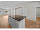 Kitchen island with granite countertops, white cabinets, hardwood floors and an open concept design at 297 Barr Link Rd, Mount Pleasant, NC 28124