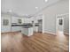 Bright kitchen with white cabinets, an island with dark countertops, and hardwood floors at 297 Barr Link Rd, Mount Pleasant, NC 28124